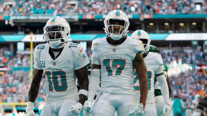 Miami Dolphins wide receiver Jaylen Waddle (17) and wide receiver Tyreek Hill (10) celebrate a touchdown and a two-point conversion during the second half of an NFL football game against the New York Jets, Sunday, Dec. 8, 2024, in Miami Gardens, Fla. (AP